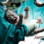 Doctor holding new born