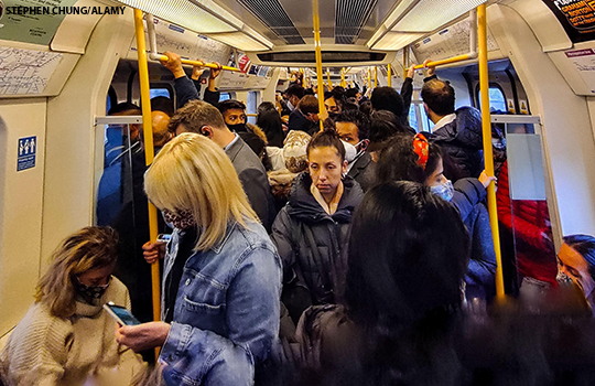Commuters on a busy tube carriage in October 2021