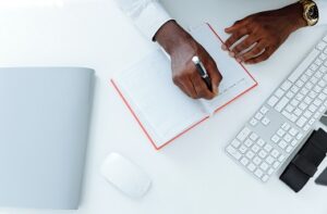 Image of hands writing in a notepad