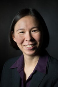 Image of blog post author, Naomi Fujita-Rohwerder. Naomi has a black bob and is wearing a purple shirt and black blazer.