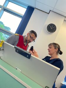 Image of 2 nurses in conversation while conducting a drugs round