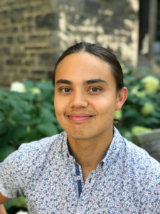 Headshot: collared shirt, hair pulled back, smiling