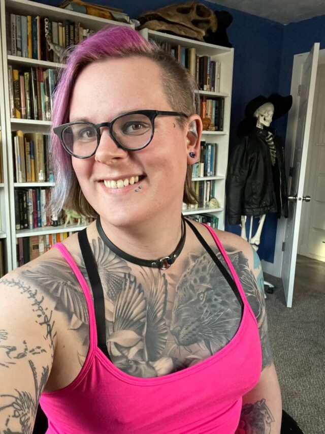 Photo of the author in a pink tank top, smiling