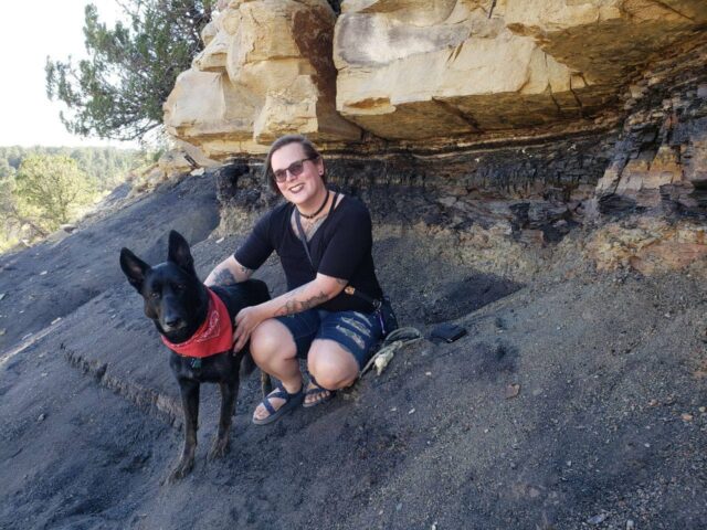 Author of the photo posing with a dog, on a hike