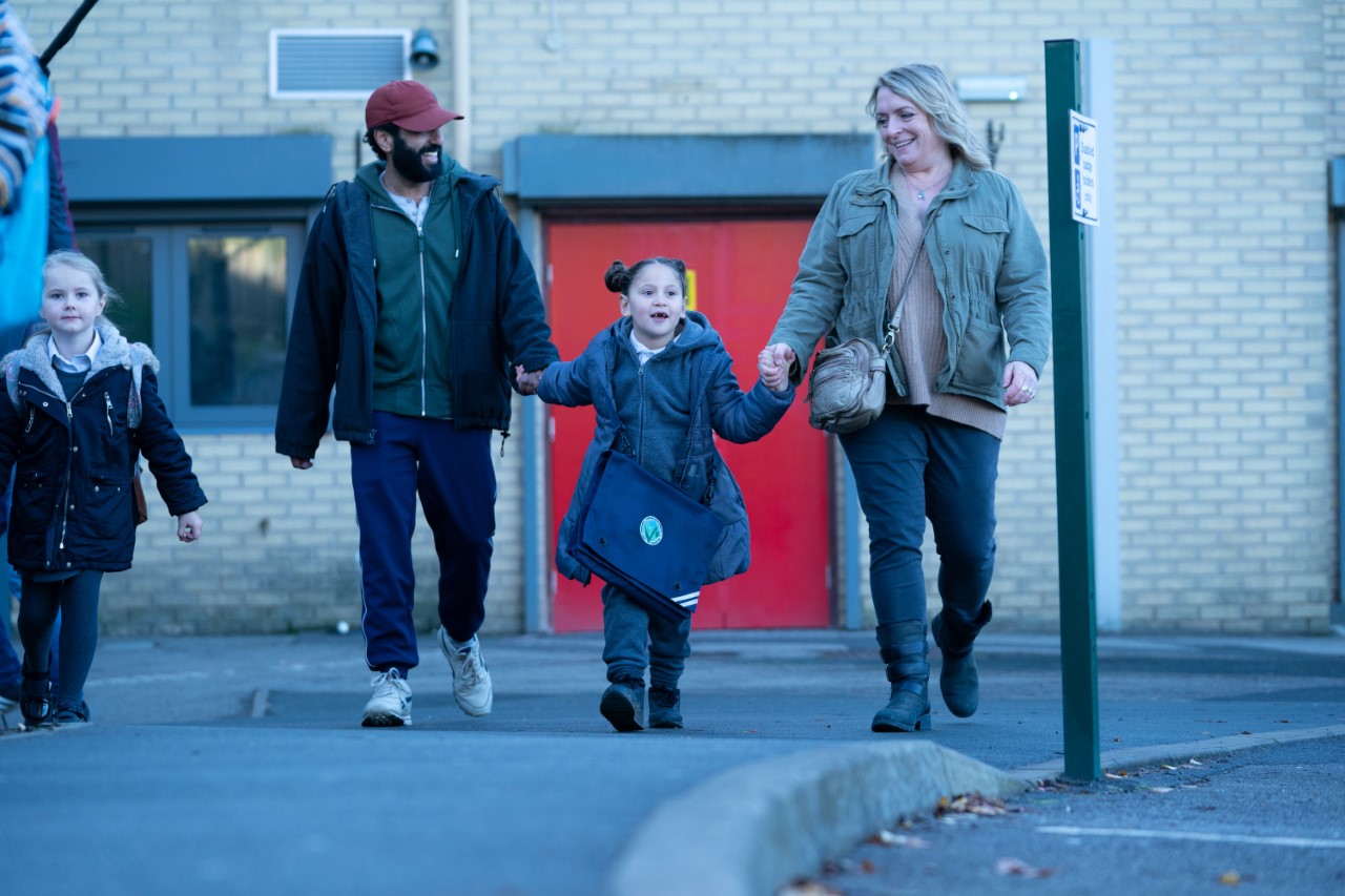 Eva (Claire Rushbrook) and Ali (Adeel Akhtar) looking after Sofia (Ariana Bodorova). 